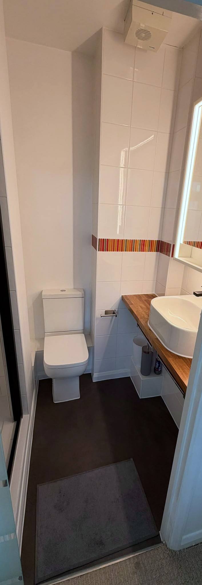 Cloakroom with vessel basin on a timber worktop