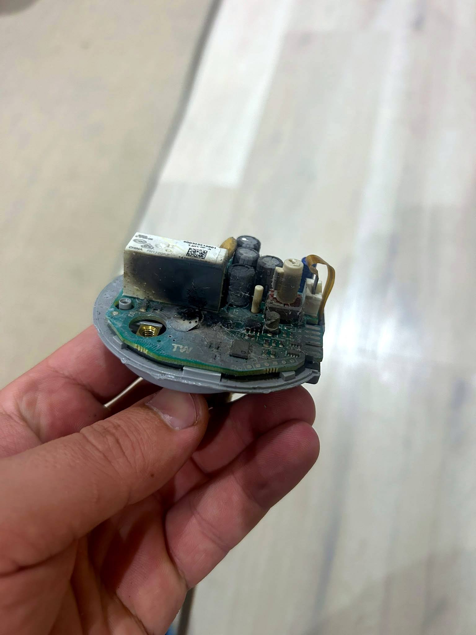 Burnt-out control board removed from a faulty fitting