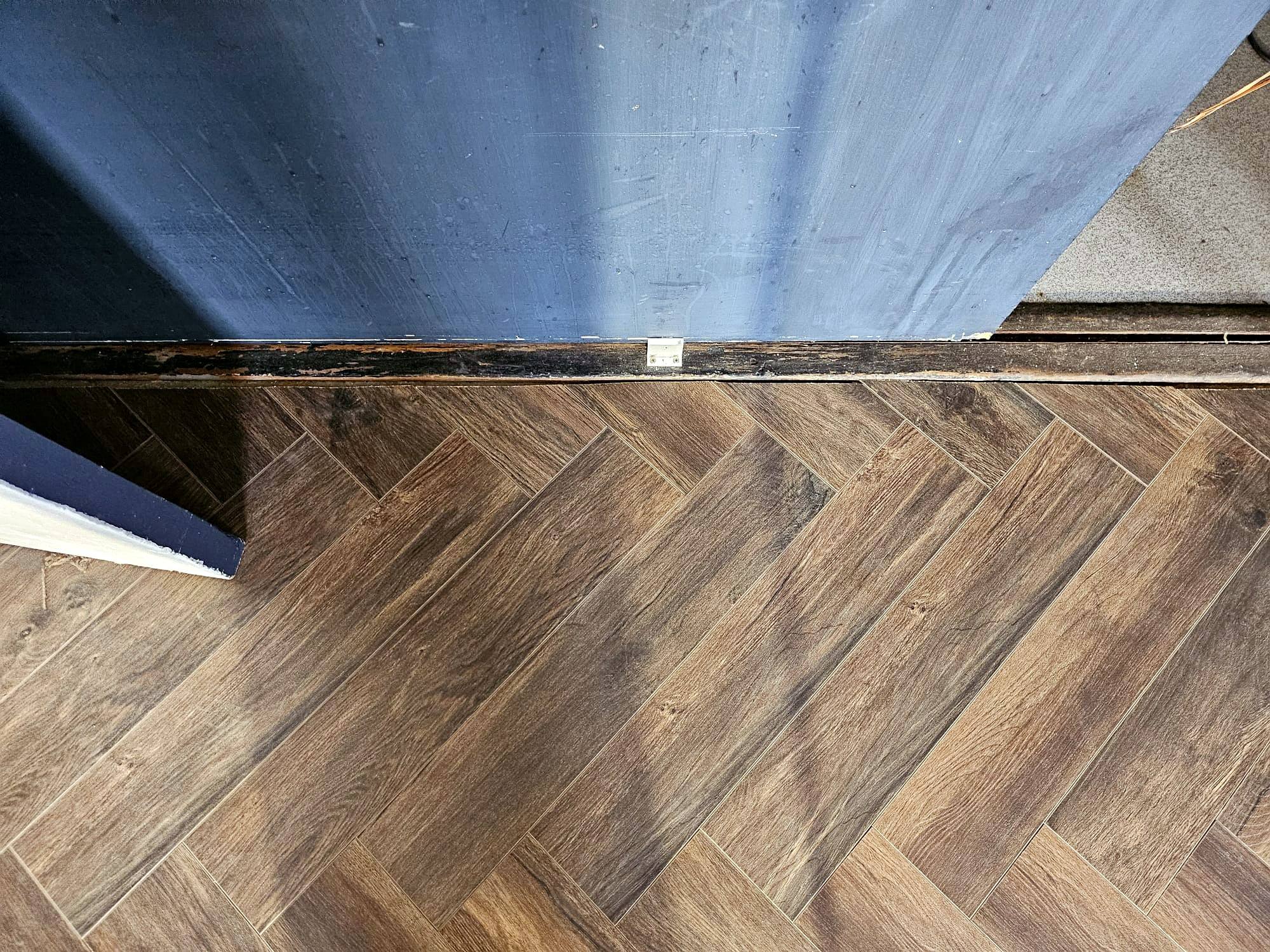 Herringbone floor meeting the skirting