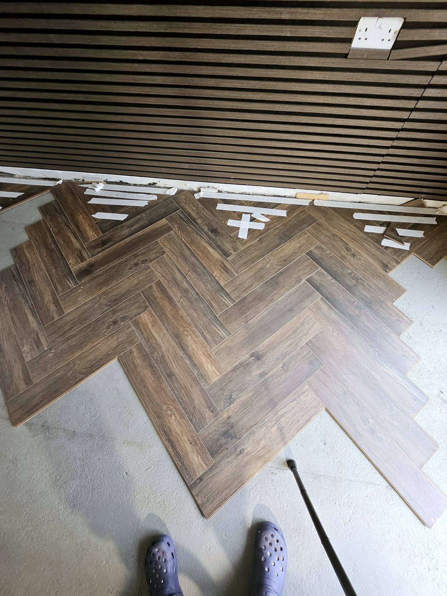 Herringbone flooring being laid