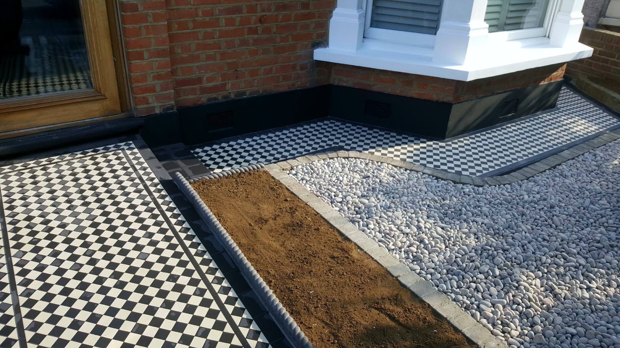 Front garden with tiled path, gravel bed and planting border
