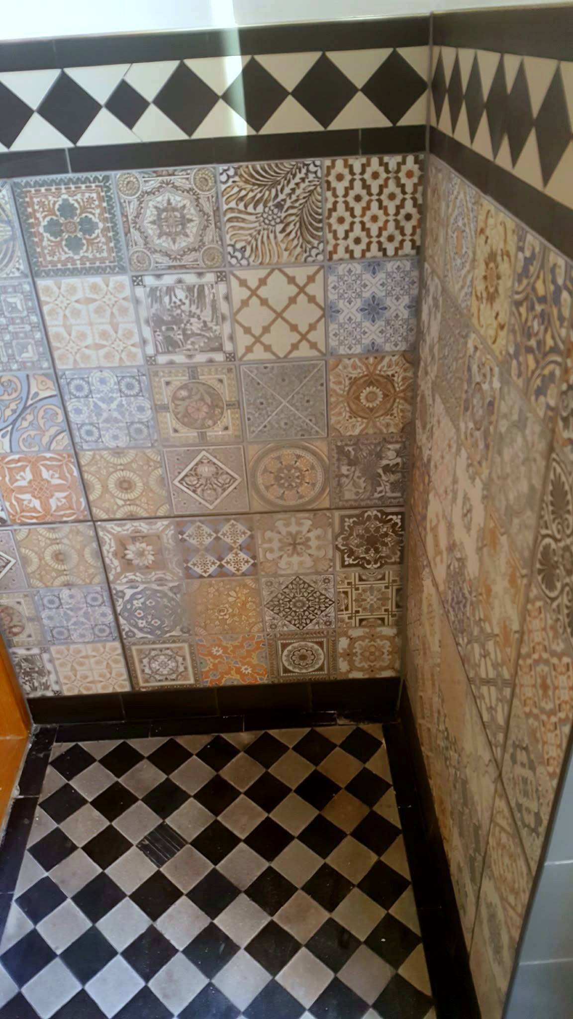 Porch with patterned wall tiles and a chequerboard floor