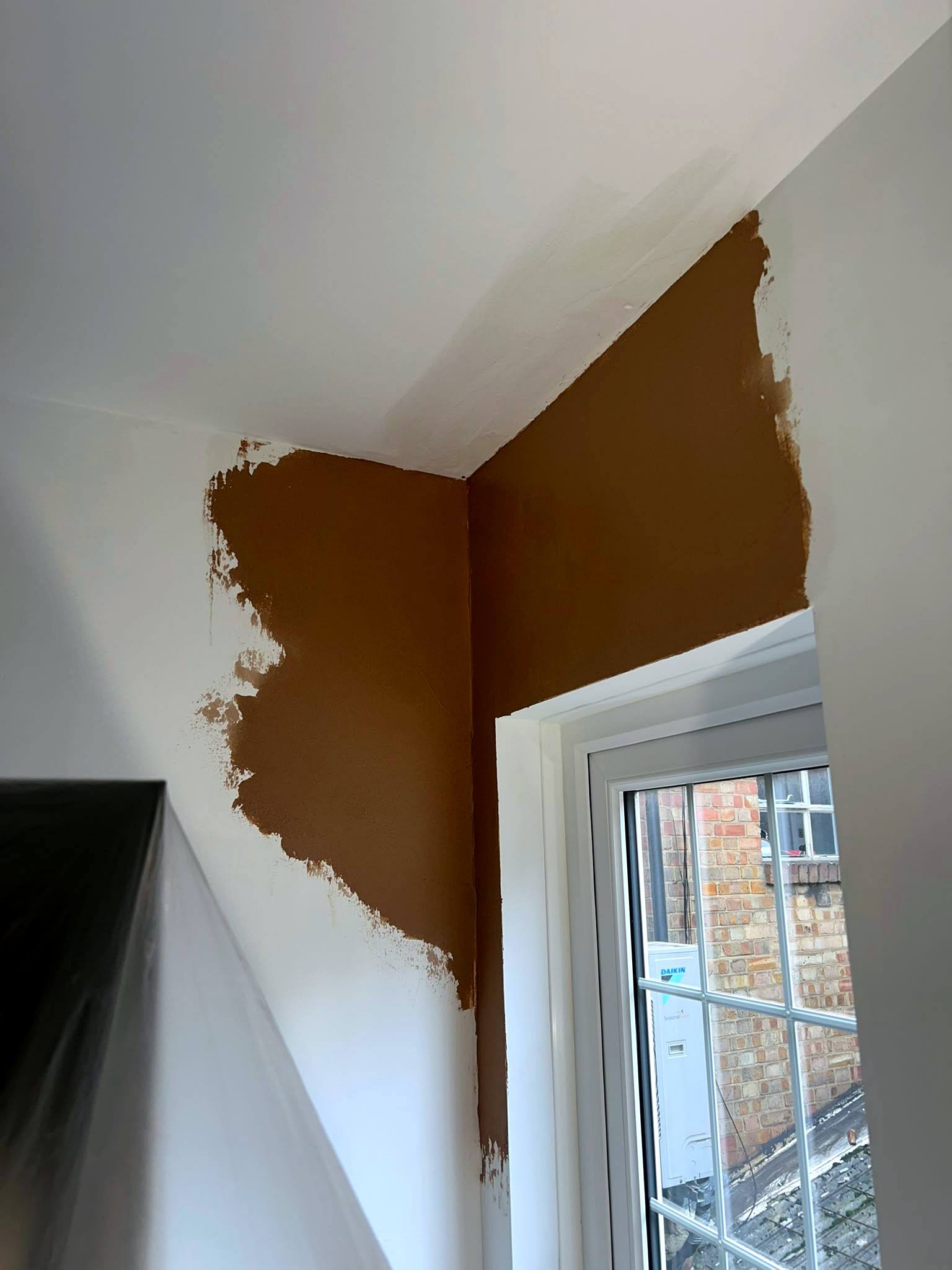 Wall patch plastered around a window