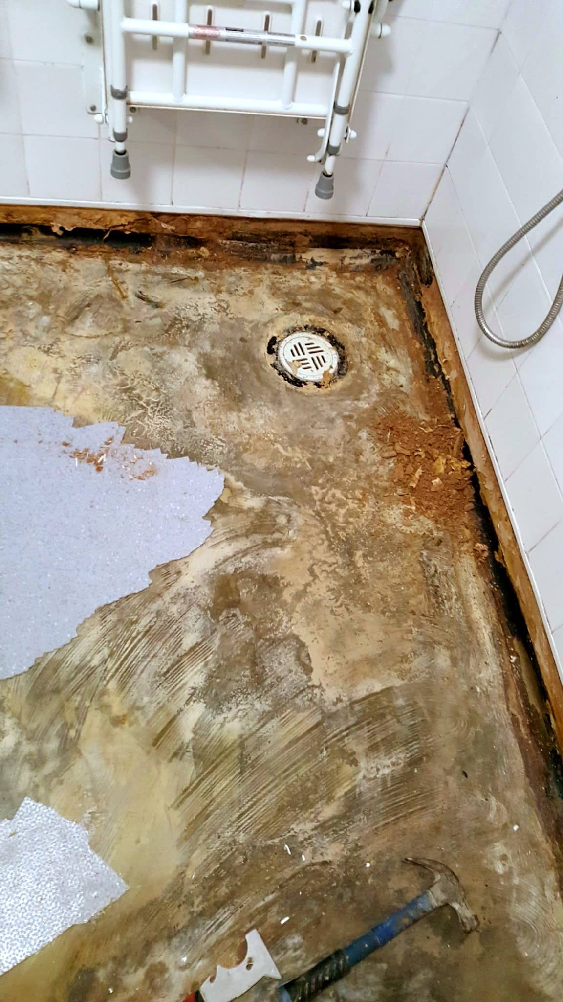 Wet room with the old floor covering lifted