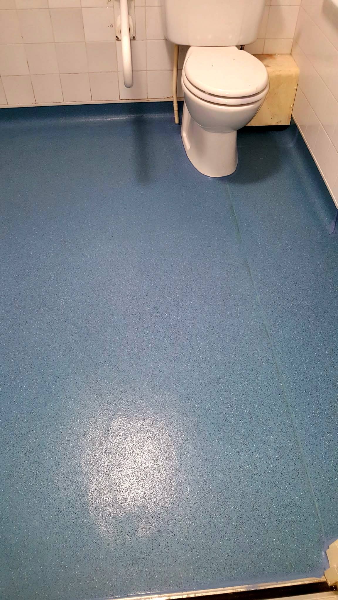 The same floor with safety flooring coved up the walls